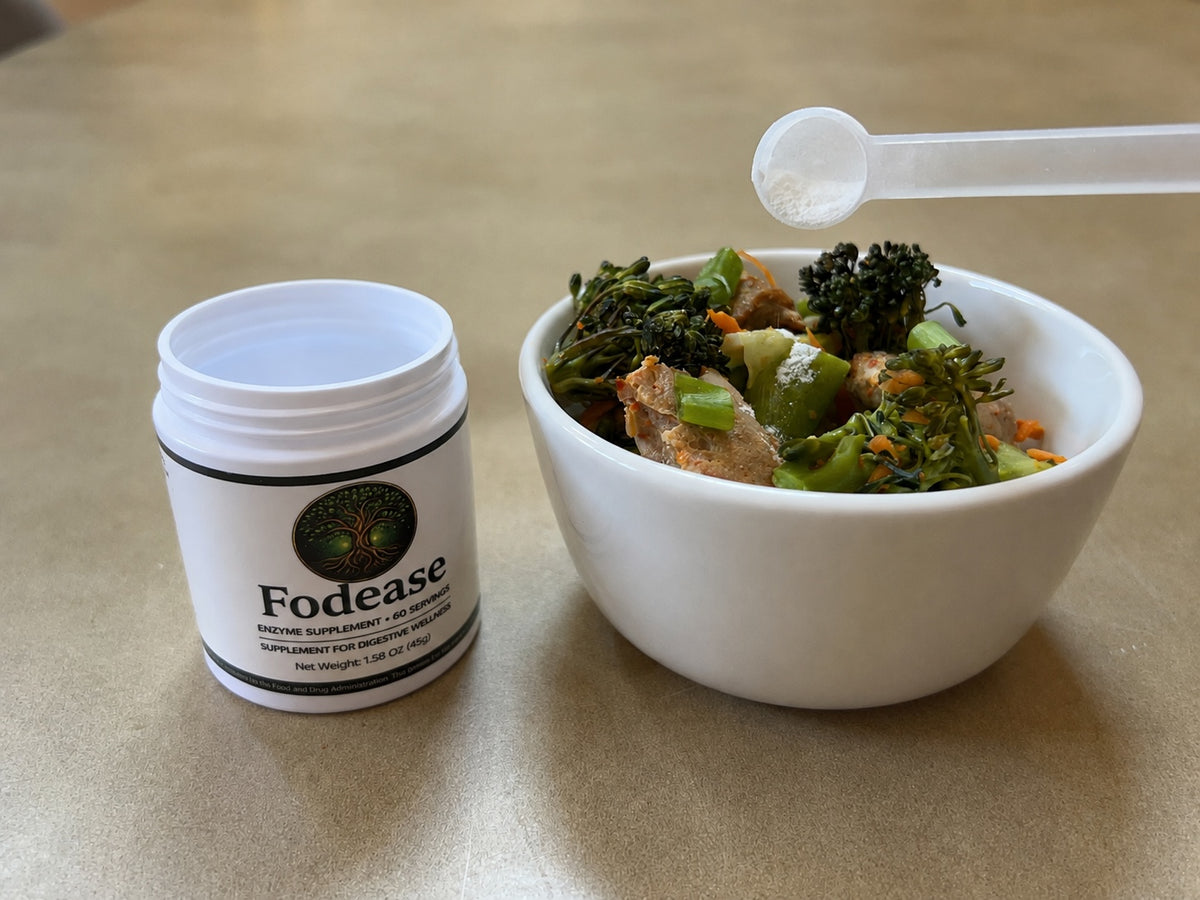 Scoop of Fodease enzyme powder being sprinkled onto a bowl of stir-fried vegetables and chicken